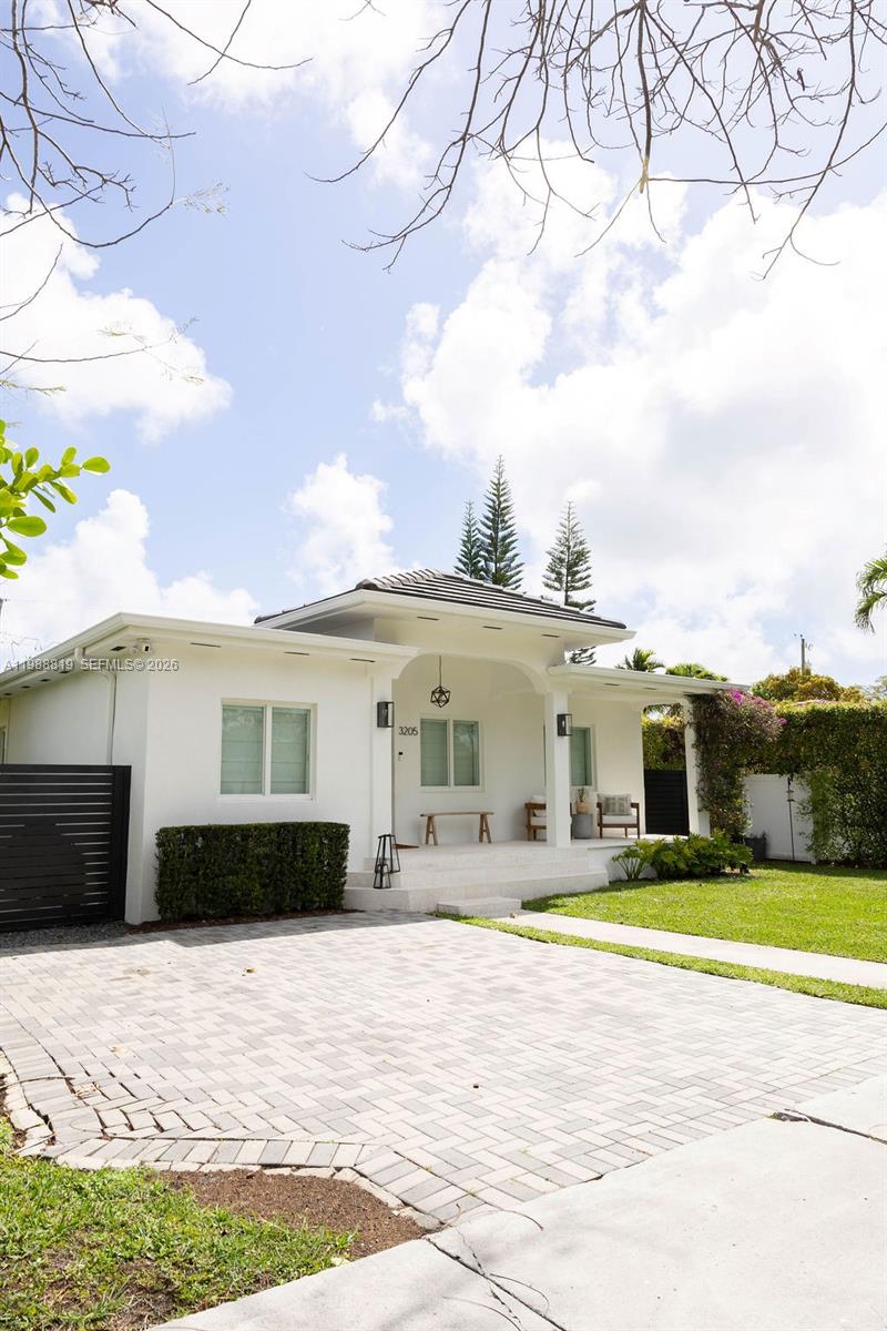 3205 Southwest 68th Avenue Miami, FL 33155 - Photo 4 of 33 a view of a white house with a yard