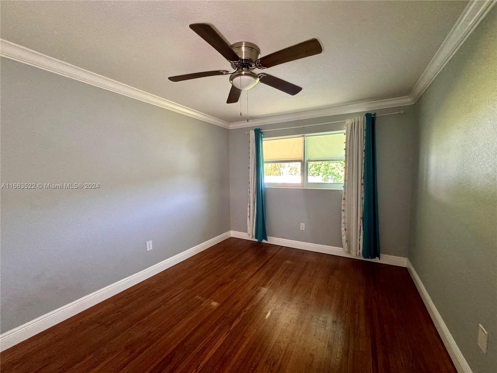 8945 Southwest 125th Terrace, Unit 8945 Miami, FL 33176 - Photo 12 of 29 wooden floor in an empty room with a window