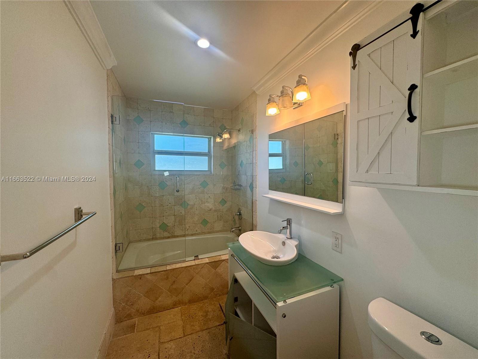 8945 Southwest 125th Terrace, Unit 8945 Miami, FL 33176 - Photo 13 of 29 a bathroom with a sink toilet and shower