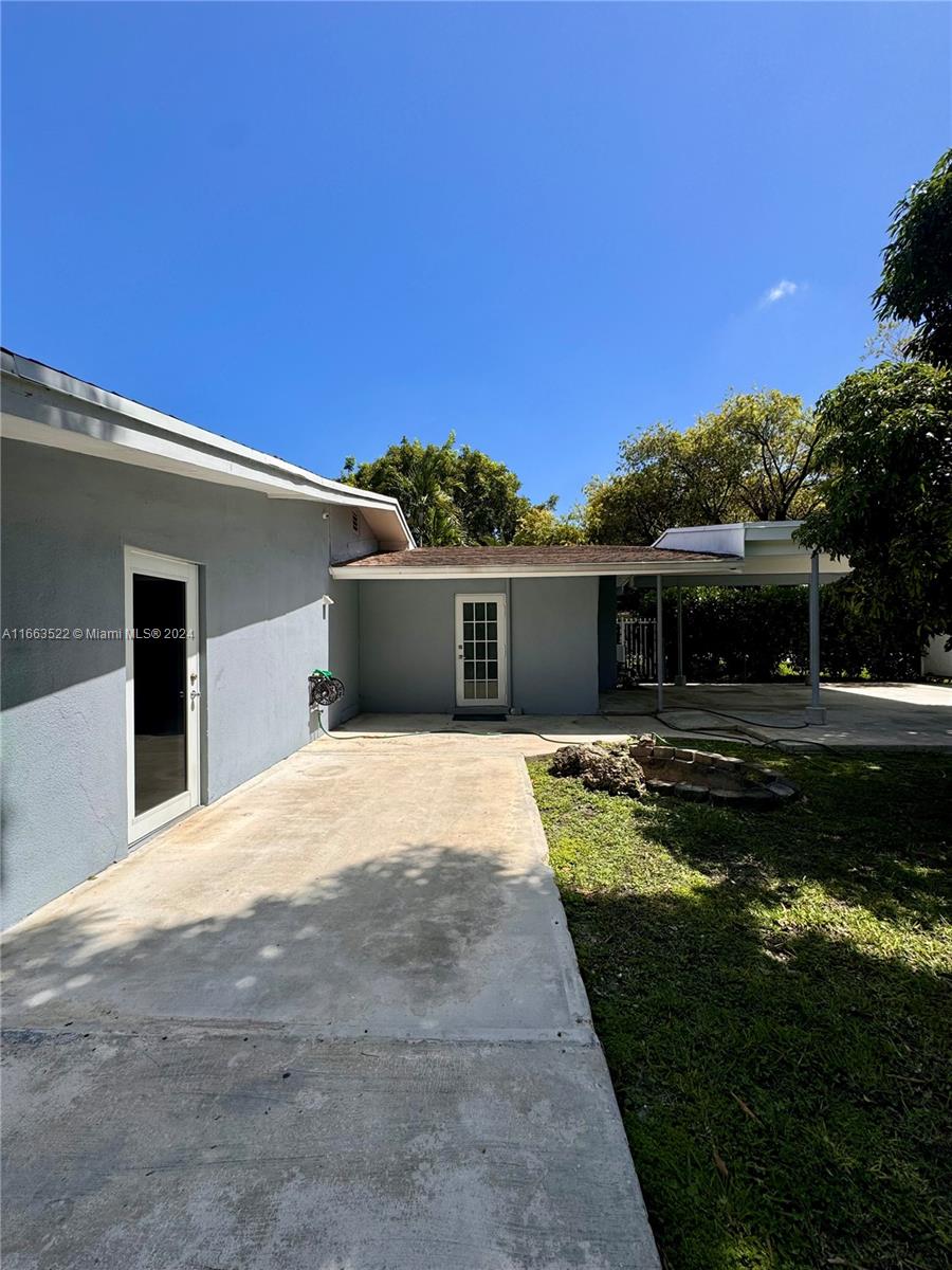8945 Southwest 125th Terrace, Unit 8945 Miami, FL 33176 - Photo 16 of 29 a front view of a house with a garden