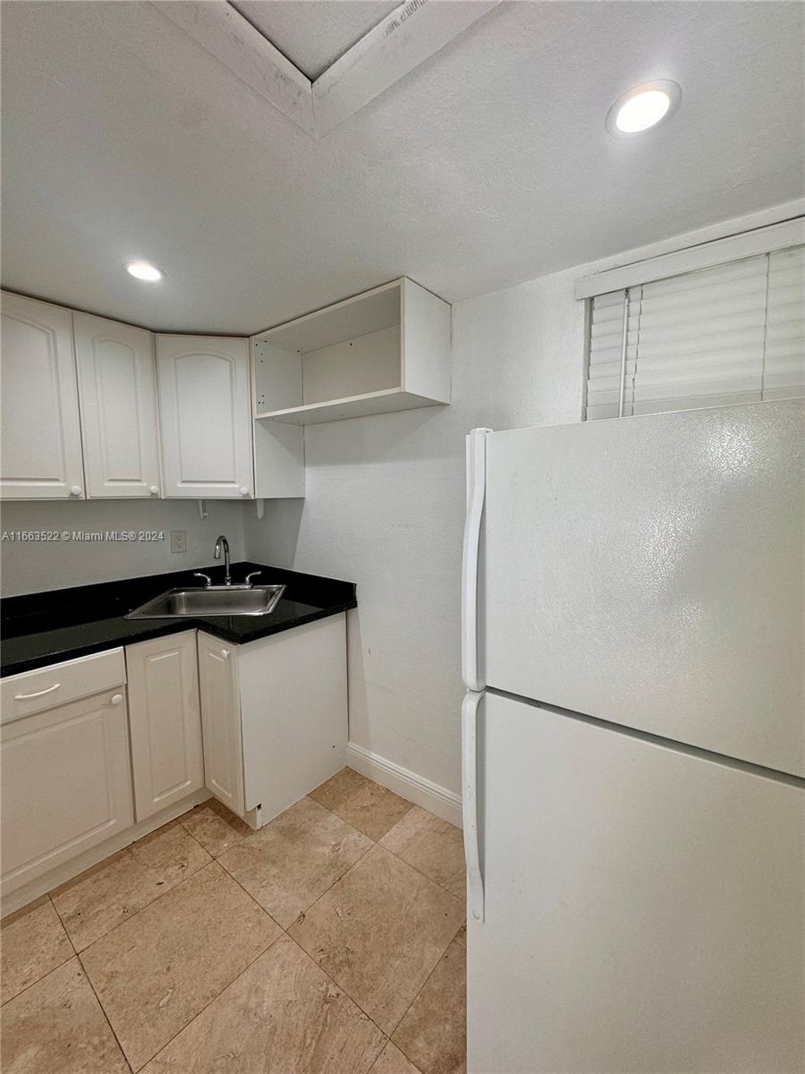 8945 Southwest 125th Terrace, Unit 8945 Miami, FL 33176 - Photo 18 of 29 a kitchen with a refrigerator and a sink