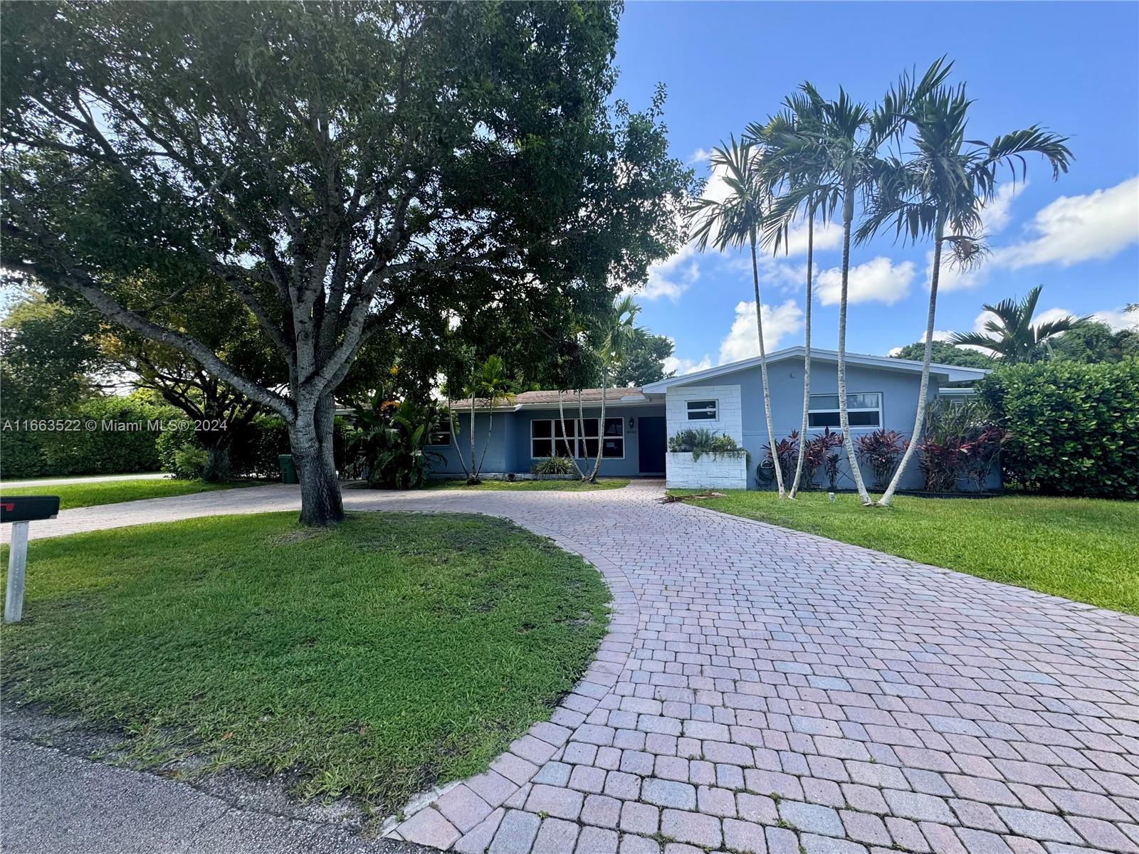 8945 Southwest 125th Terrace, Unit 8945 Miami, FL 33176 - Photo 23 of 29 a front view of a house with garden