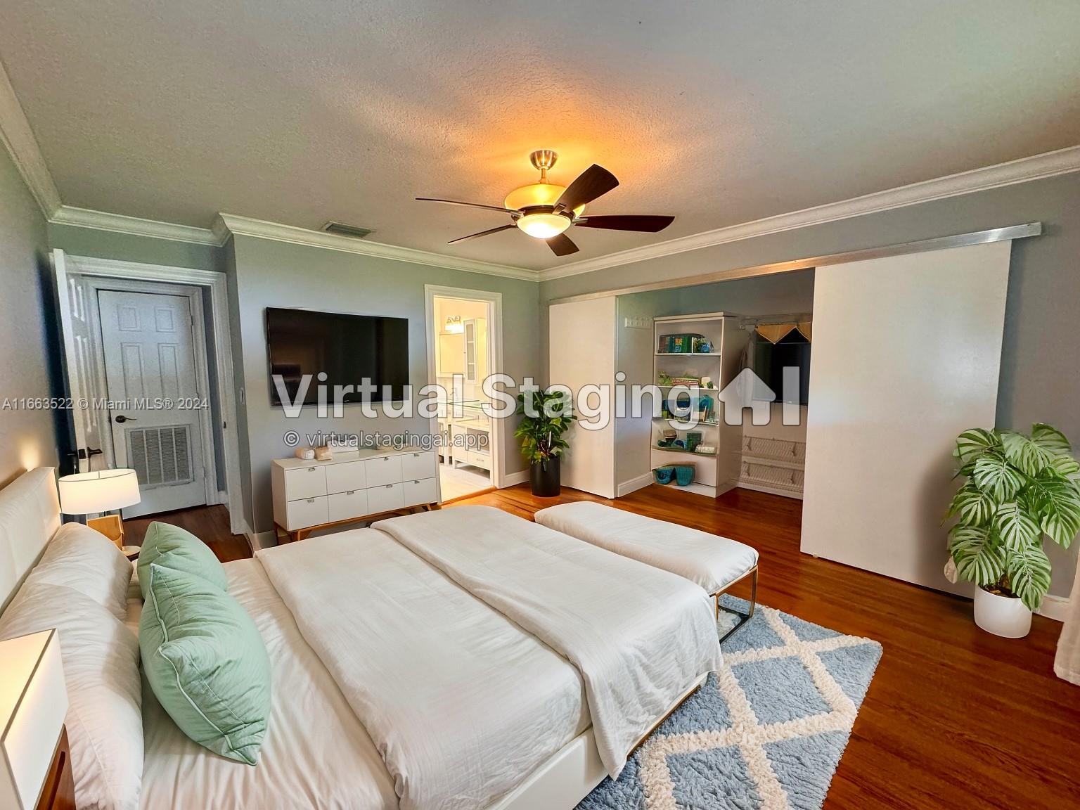 8945 Southwest 125th Terrace, Unit 8945 Miami, FL 33176 - Photo 27 of 29 a bedroom with a bed and a large mirror with wooden floor