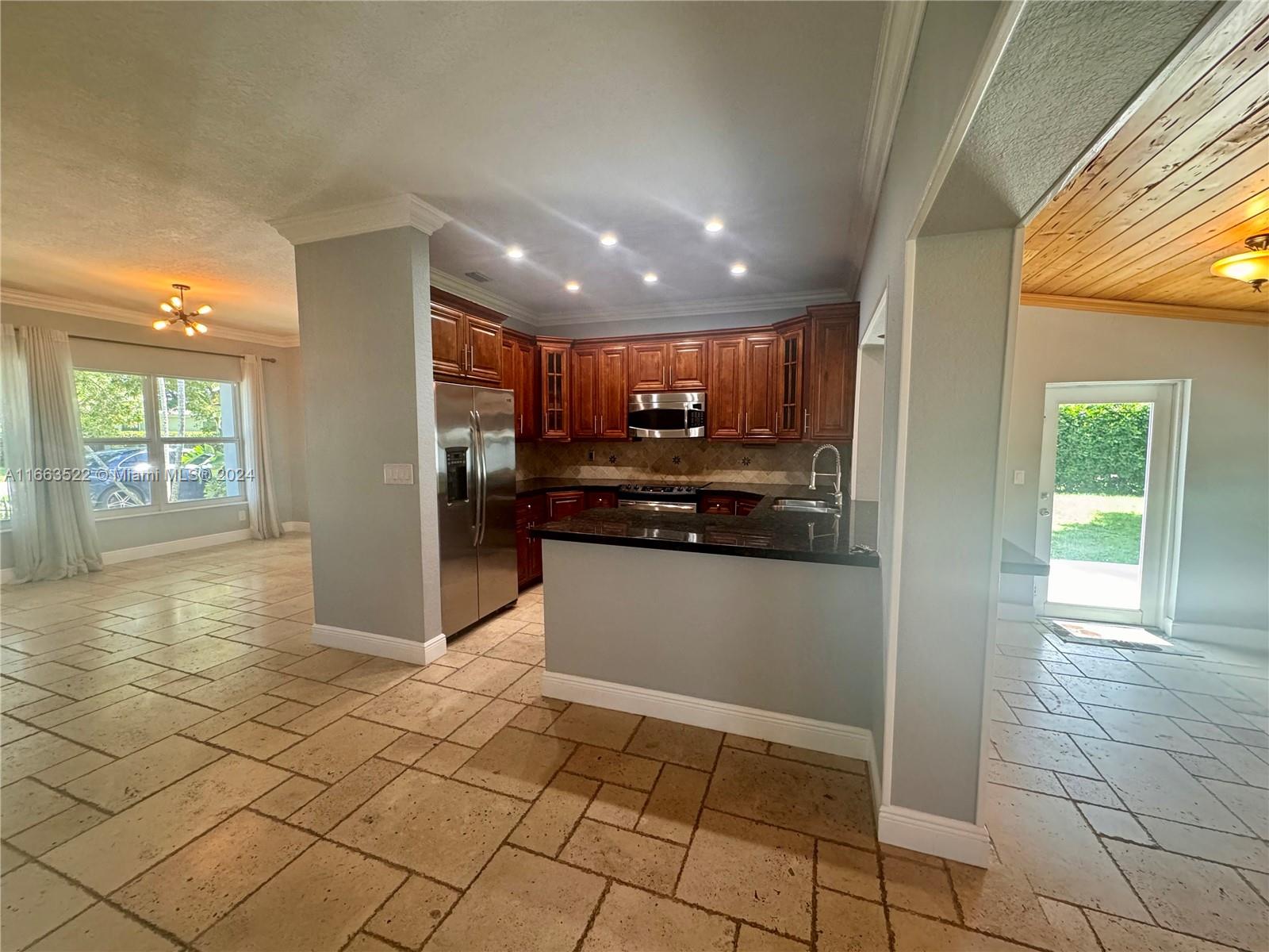 8945 Southwest 125th Terrace, Unit 8945 Miami, FL 33176 - Photo 5 of 29 a open kitchen with stainless steel appliances granite countertop a refrigerator and a sink