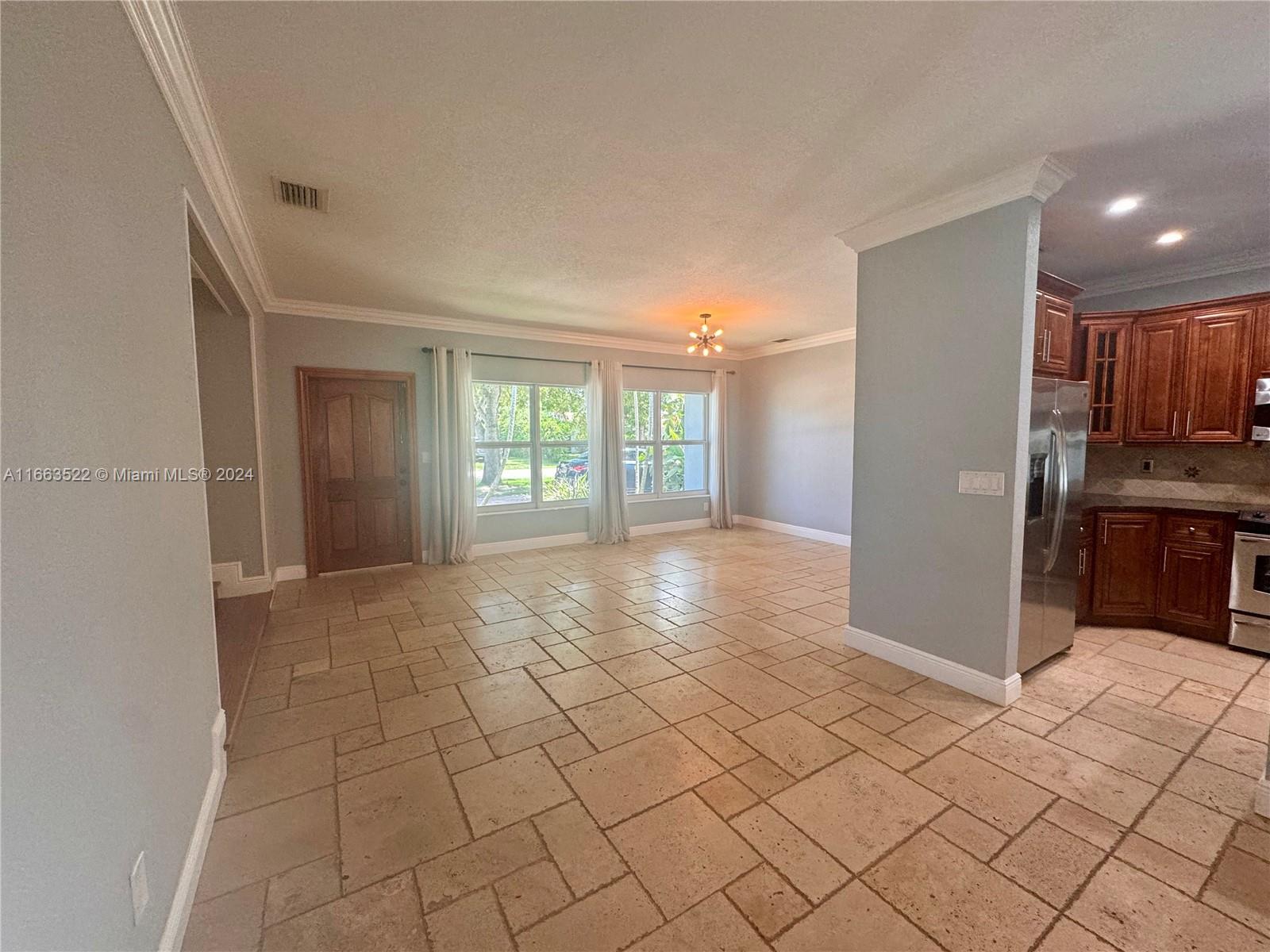 8945 Southwest 125th Terrace, Unit 8945 Miami, FL 33176 - Photo 7 of 29 a view of a kitchen with a refrigerator and cabinets