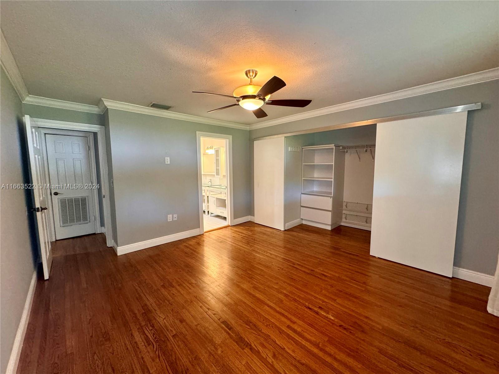 8945 Southwest 125th Terrace, Unit 8945 Miami, FL 33176 - Photo 8 of 29 a view of an empty room with wooden floor and a window