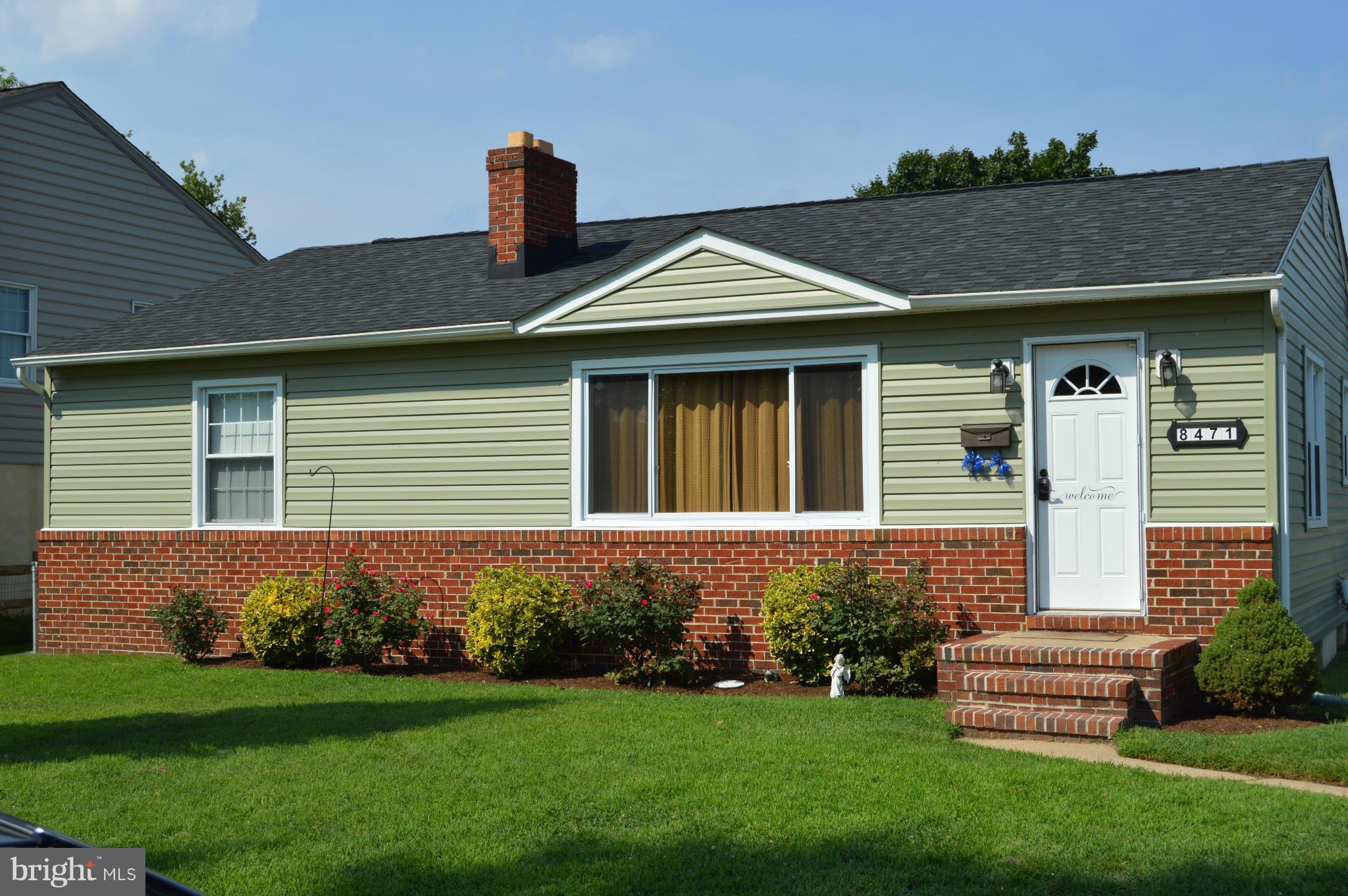 8471 Church Road Pasadena, MD 21122 - Photo 1 of 18 a front view of a house with a garden