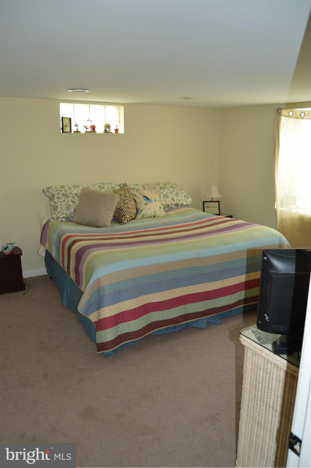 8471 Church Road Pasadena, MD 21122 - Photo 14 of 18 a bedroom with bed and window