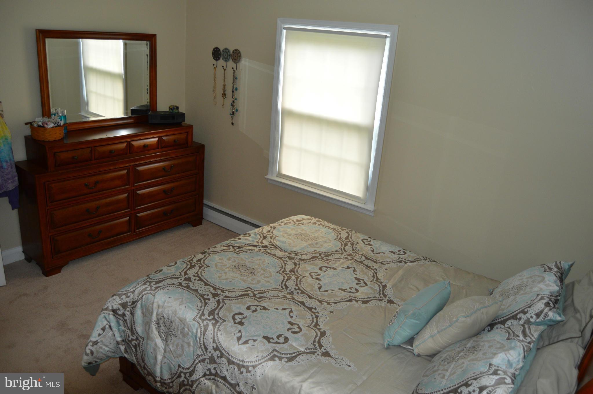 8471 Church Road Pasadena, MD 21122 - Photo 7 of 18 a bed in a bedroom next to a window