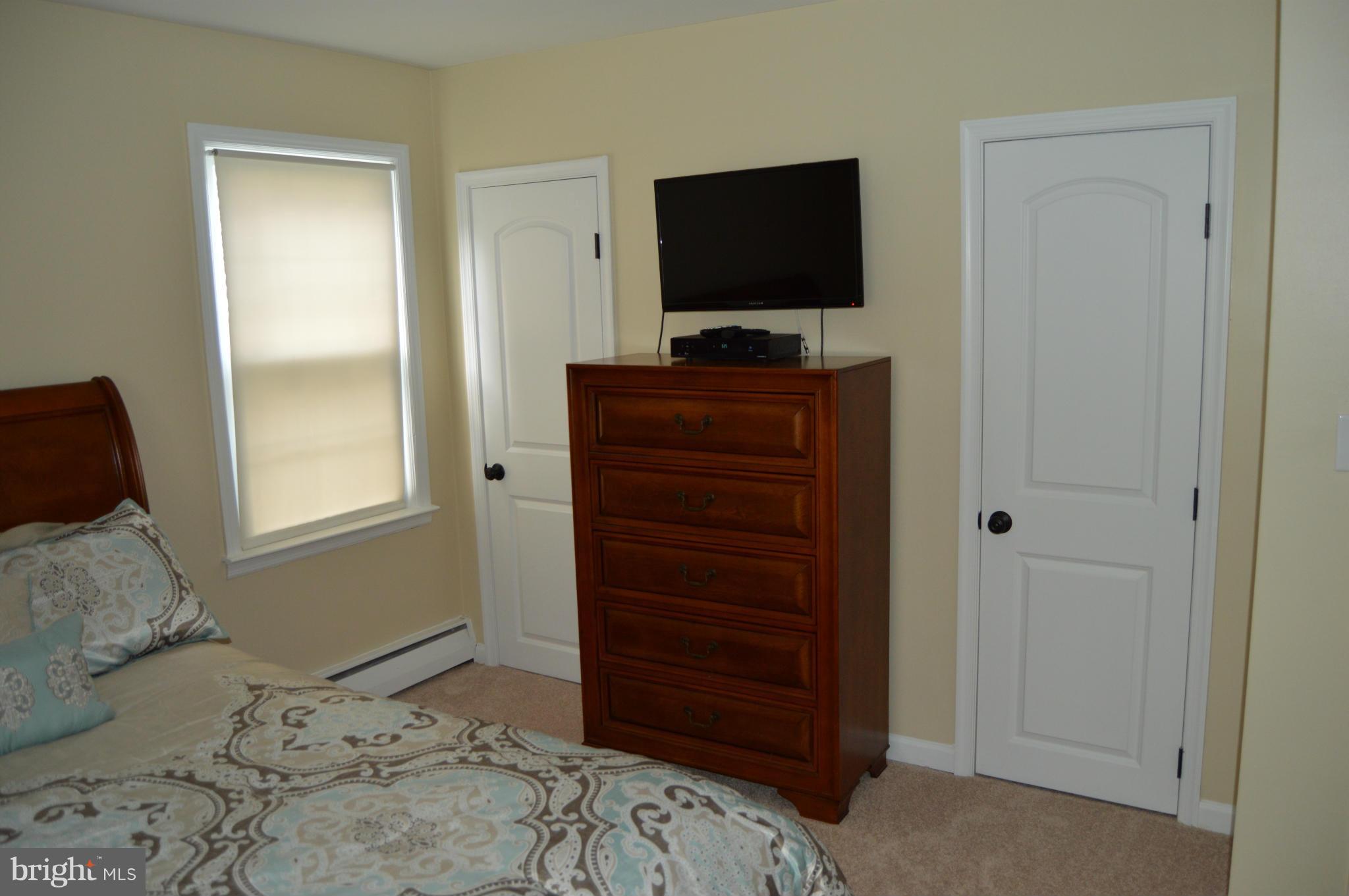 8471 Church Road Pasadena, MD 21122 - Photo 8 of 18 a bedroom with a bed and a flat screen tv