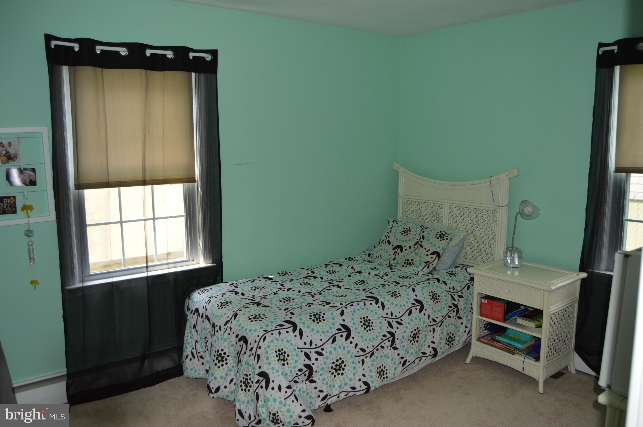8471 Church Road Pasadena, MD 21122 - Photo 10 of 18 a bed sitting in a bedroom next to a window