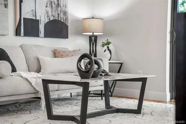 a view of a dining room with furniture clock and wooden floor