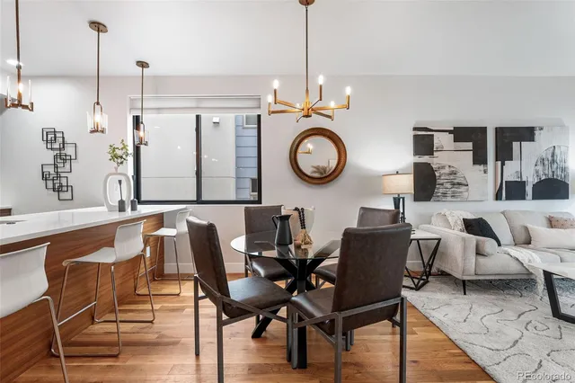 a living room with furniture a lamp and a large mirror
