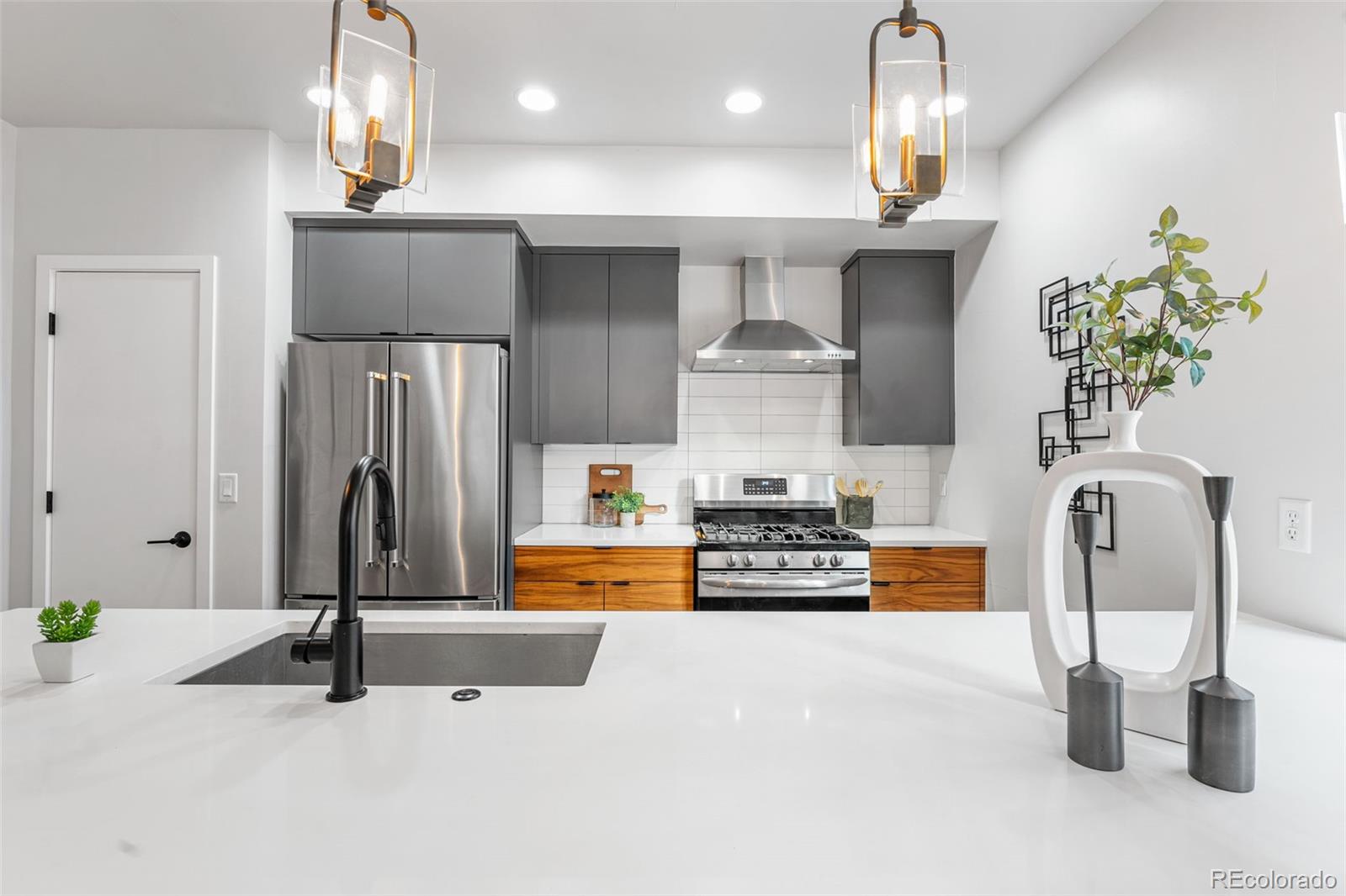 3644 Quivas Street, Unit 2 Denver, CO 80211 - Photo 17 of 49 a kitchen with stainless steel appliances granite countertop a refrigerator and a stove