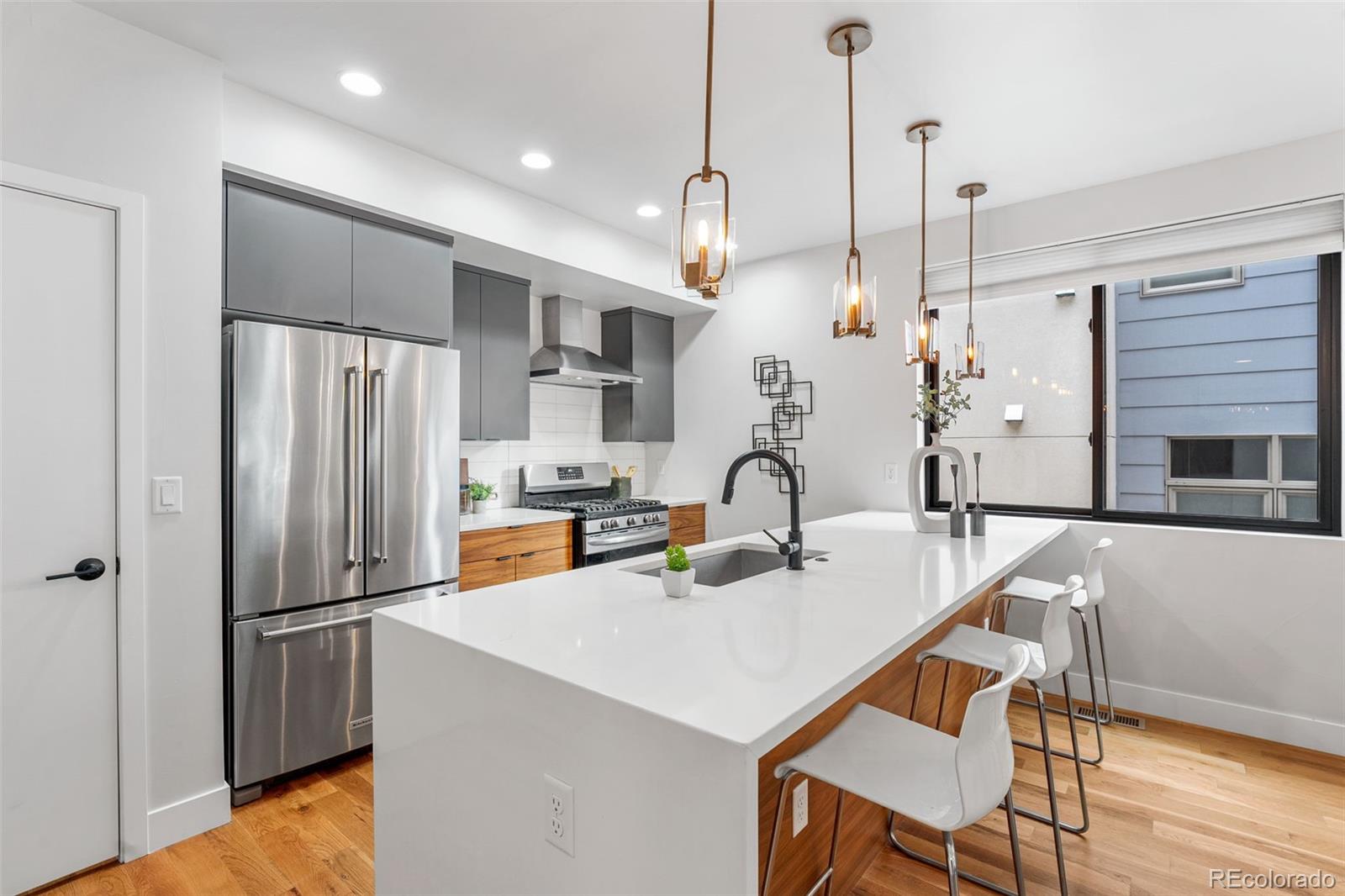 3644 Quivas Street, Unit 2 Denver, CO 80211 - Photo 20 of 49 a kitchen with refrigerator a table and chairs