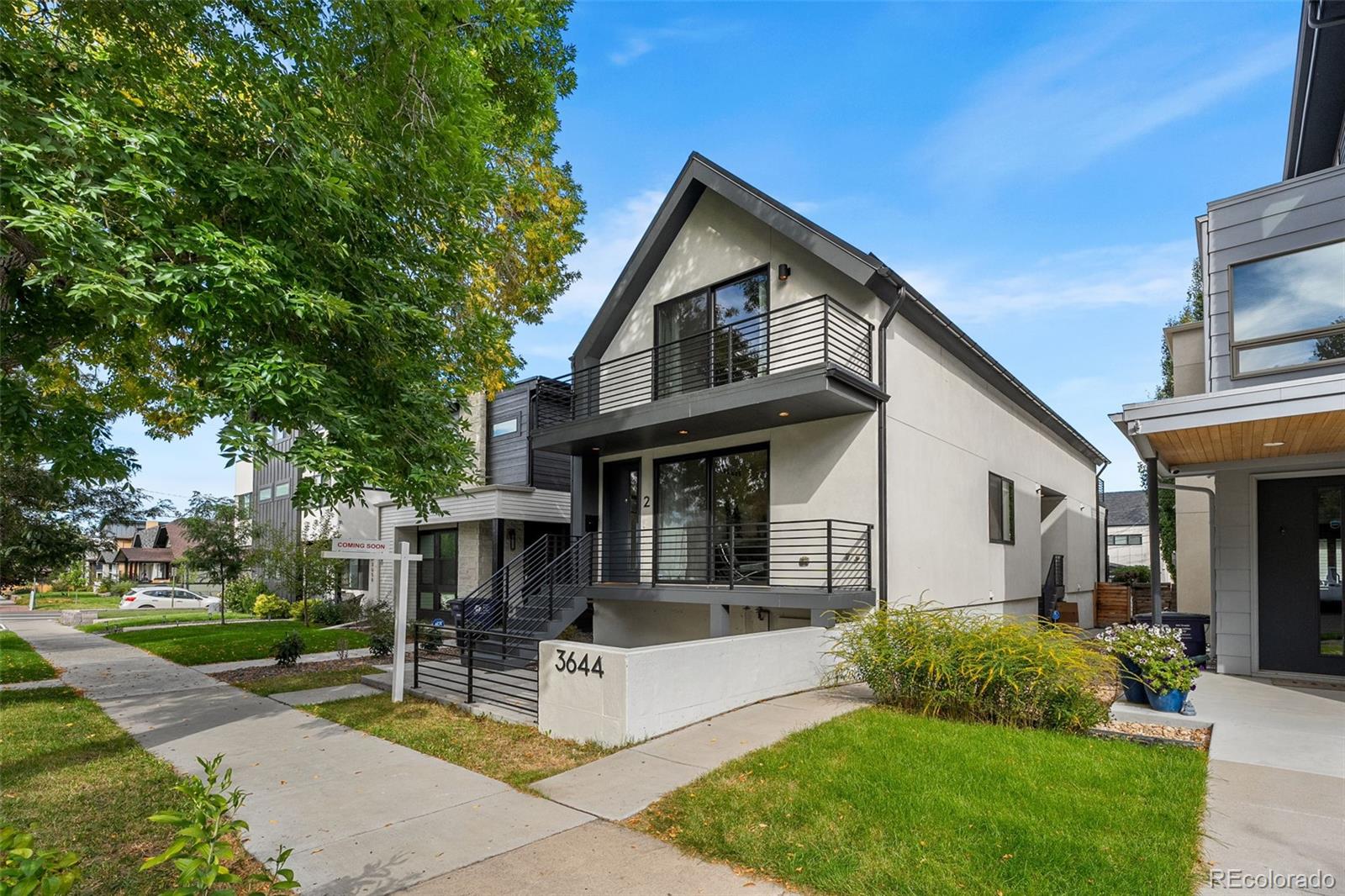 3644 Quivas Street, Unit 2 Denver, CO 80211 - Photo 2 of 49 a front view of a house with a garden and trees