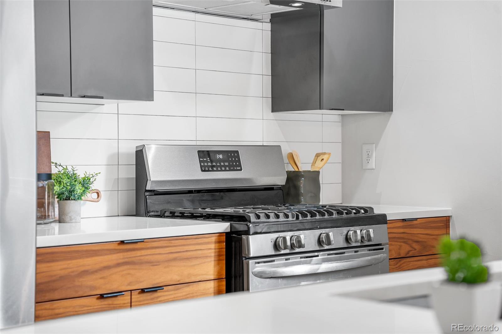 3644 Quivas Street, Unit 2 Denver, CO 80211 - Photo 21 of 49 a kitchen with stainless steel appliances granite countertop a stove and a refrigerator