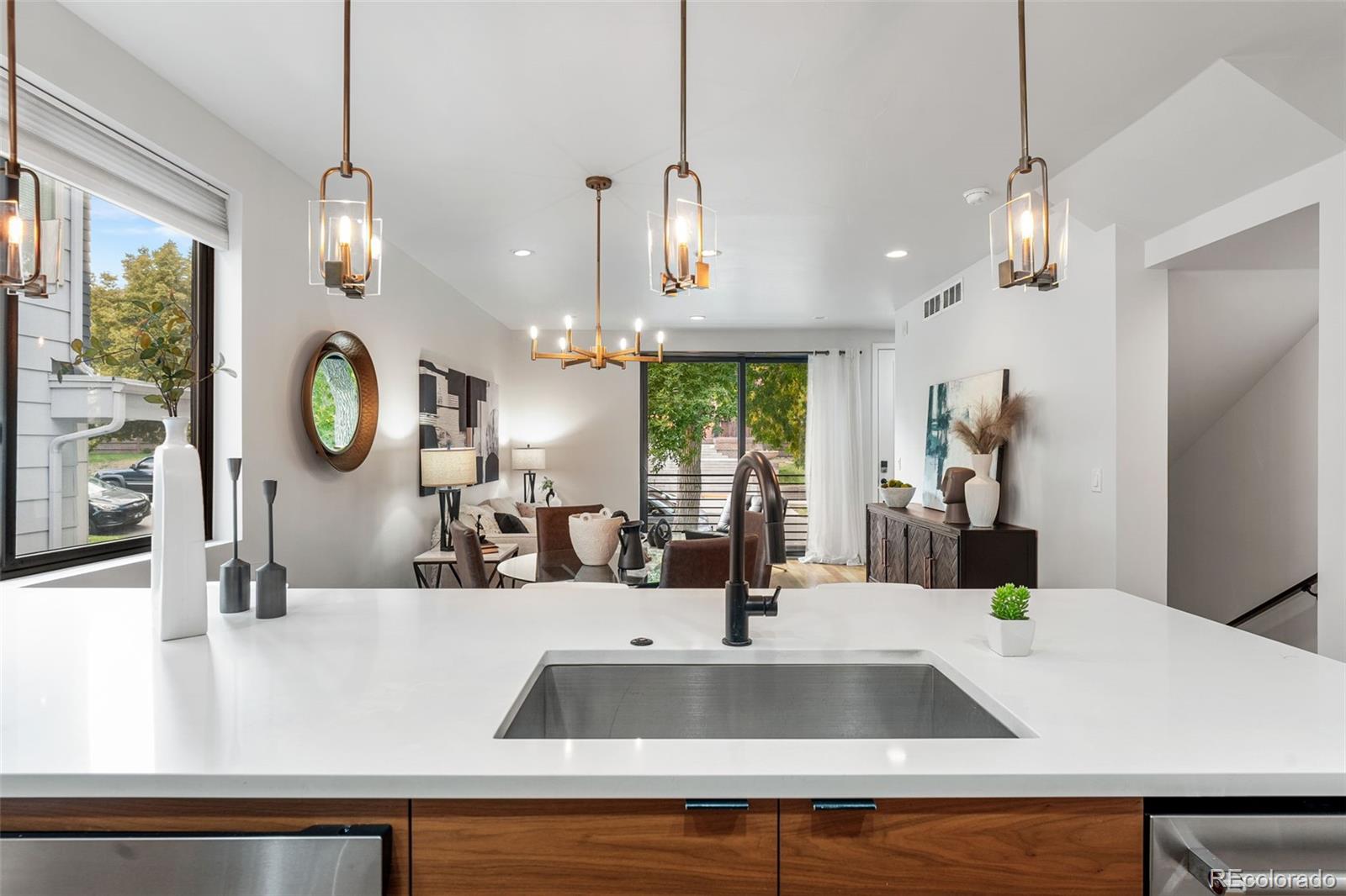 3644 Quivas Street, Unit 2 Denver, CO 80211 - Photo 23 of 49 a kitchen with a sink a counter top space and living room view