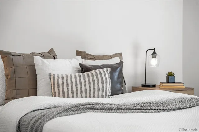 a bedroom with a bed and a large window