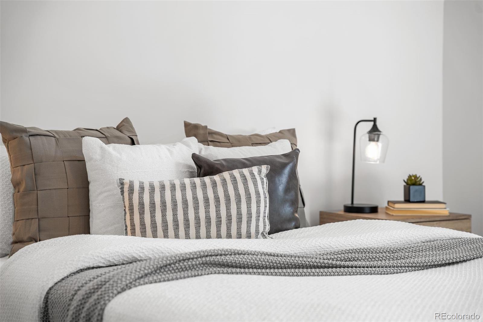 3644 Quivas Street, Unit 2 Denver, CO 80211 - Photo 30 of 49 a bedroom with a bed and a lamp