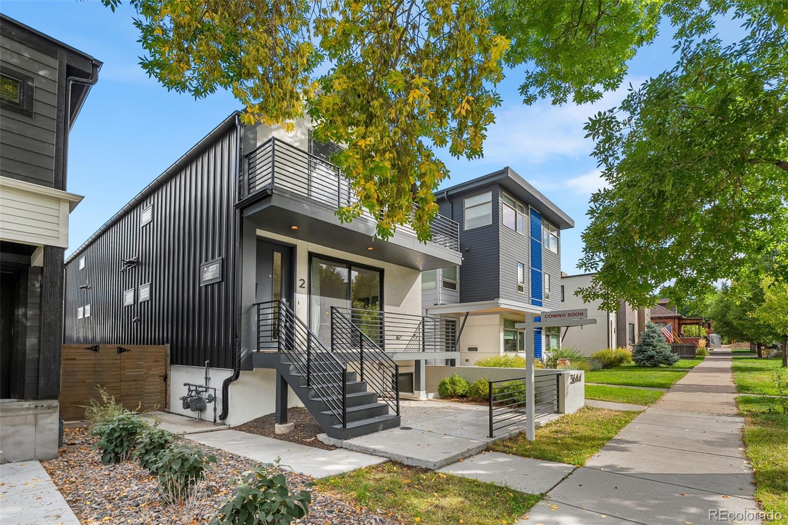 3644 Quivas Street, Unit 2 Denver, CO 80211 - Photo 3 of 49 a front view of a house with a yard glass top table and chairs