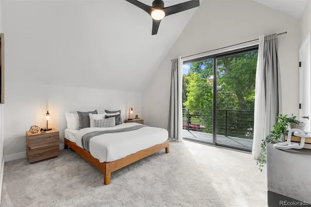 a bedroom with a bed and potted plant