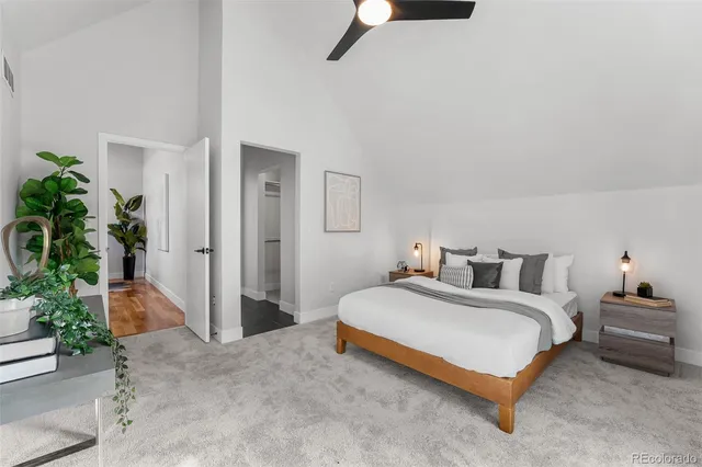 a bedroom with furniture and a potted plant