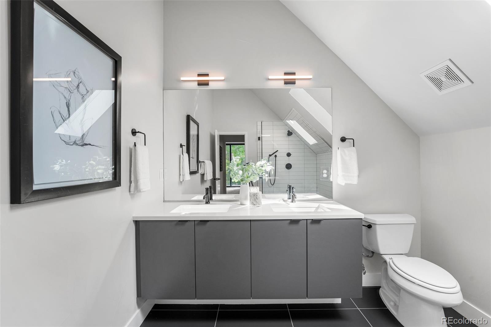 3644 Quivas Street, Unit 2 Denver, CO 80211 - Photo 36 of 49 a bathroom with a toilet sink and mirror