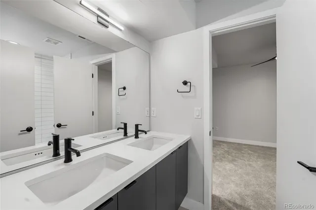 an empty room with closet and windows