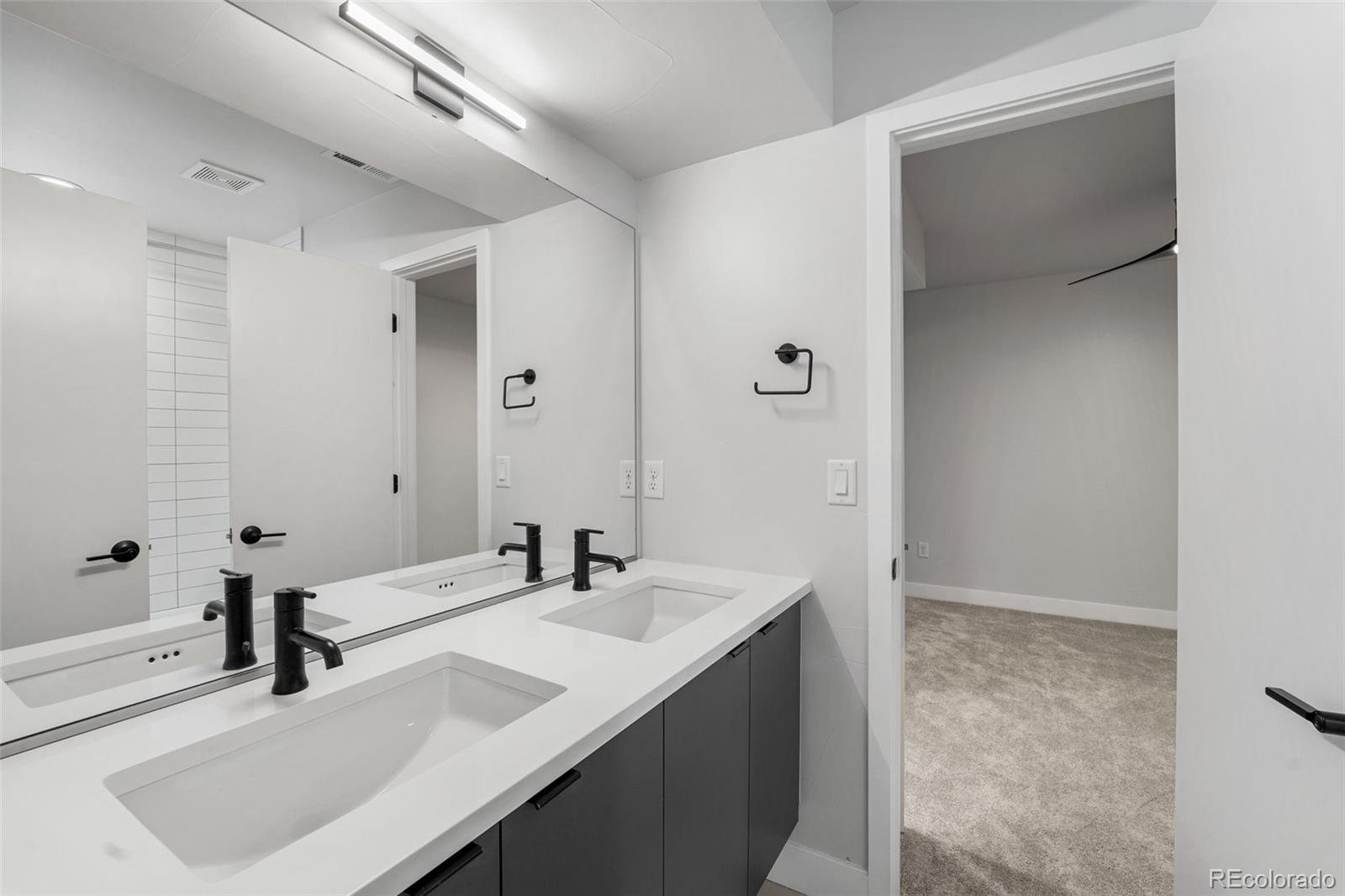 3644 Quivas Street, Unit 2 Denver, CO 80211 - Photo 41 of 49 a bathroom with a sink and a mirror