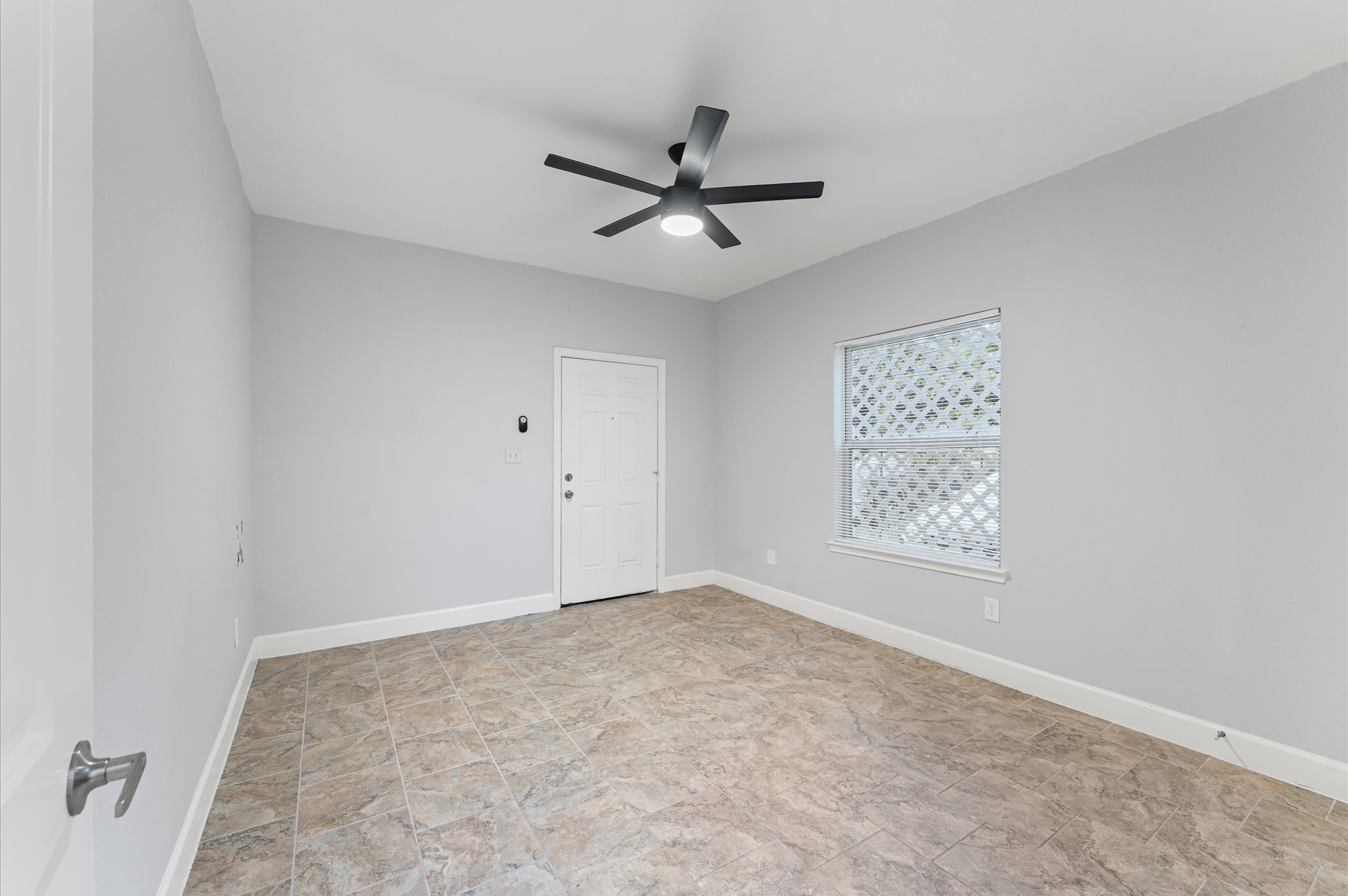 8221 Brockton Street Houston, TX 77017 - Photo 6 of 12 an empty room with a window and a fan
