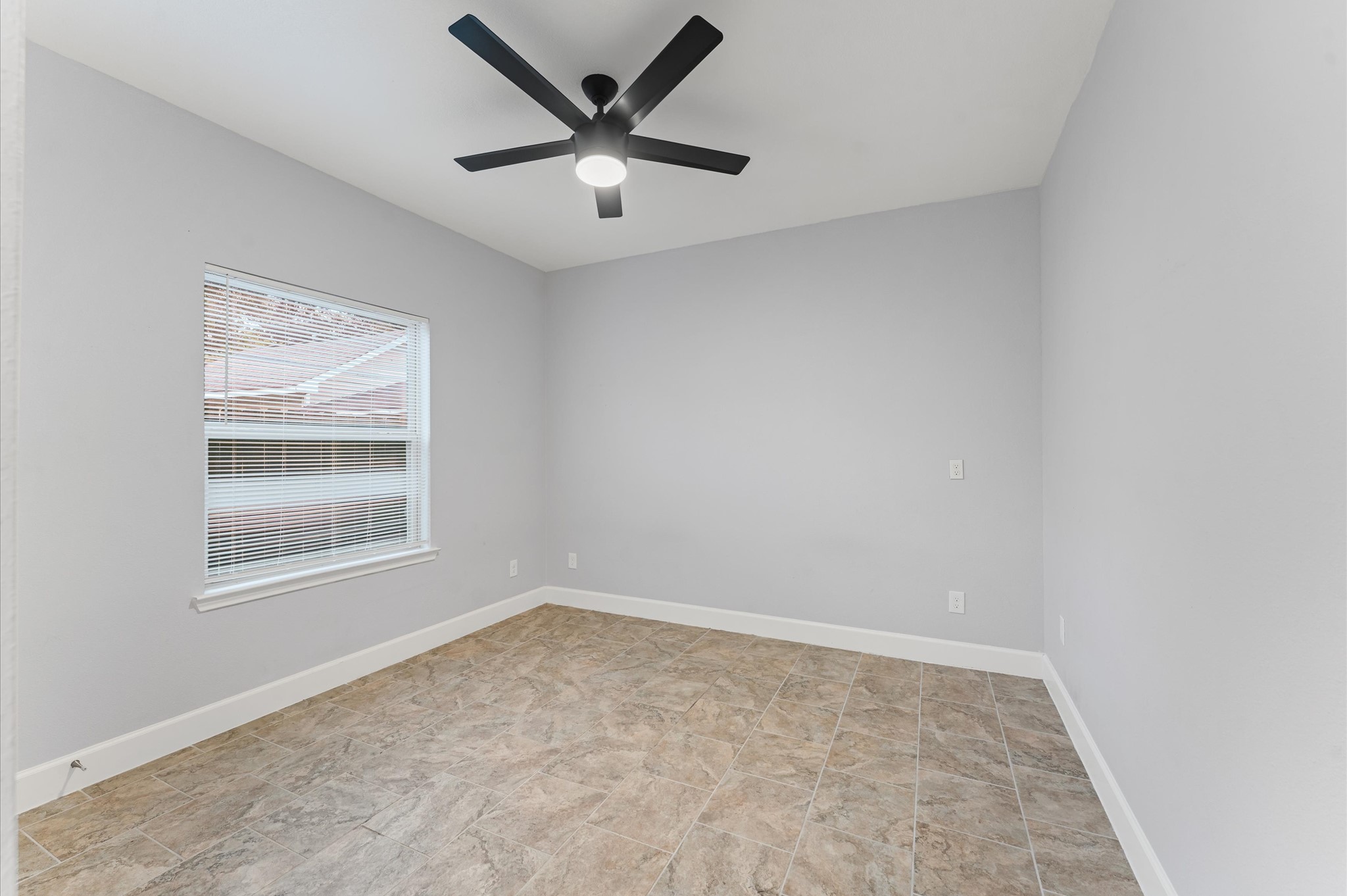 8221 Brockton Street Houston, TX 77017 - Photo 8 of 12 an empty room with a window and a ceiling fan