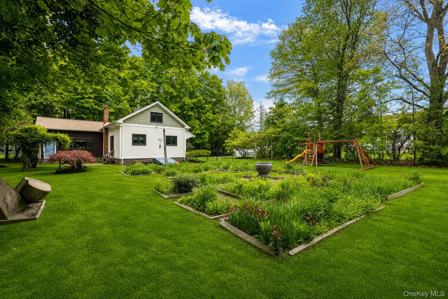 4 Clove Branch Road Hopewell Junction, NY 12533 - Photo 21 of 32 a front view of a house with garden