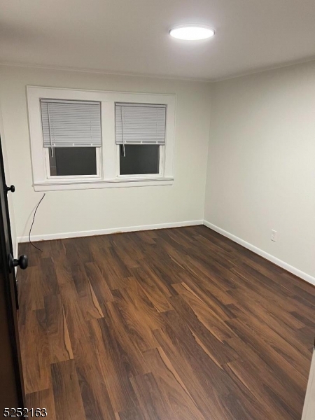 1026 Woolley Avenue Union, NJ 07083 - Photo 4 of 7 a view of an empty room with wooden floor and a window