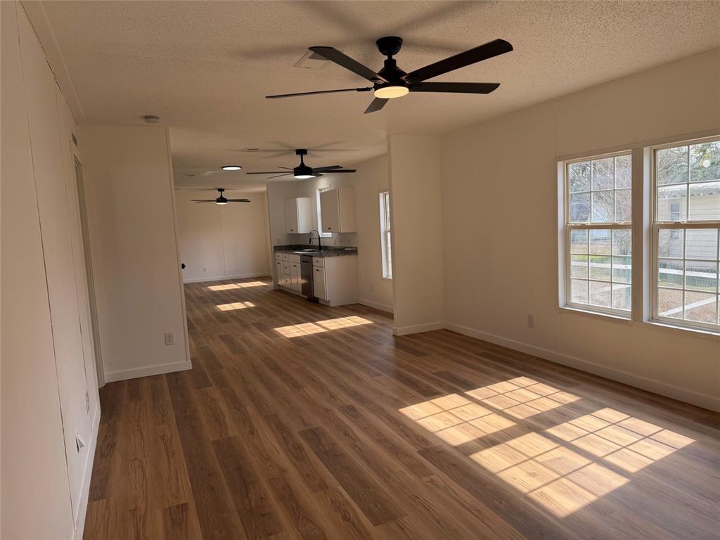 28834 Hubbard Street Leesburg, FL 34748 - Photo 12 of 22 a view of empty room with wooden floor and fan