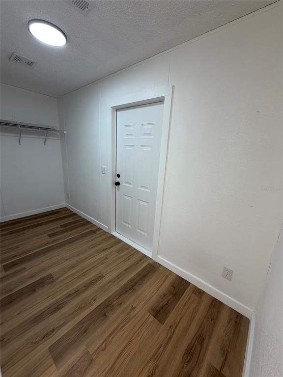 28834 Hubbard Street Leesburg, FL 34748 - Photo 14 of 22 wooden floor in an empty room