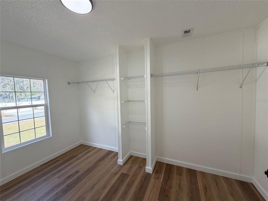 28834 Hubbard Street Leesburg, FL 34748 - Photo 16 of 22 a view of small space with wooden floor and windows