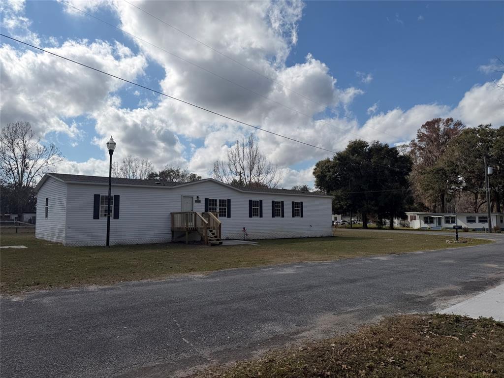 28834 Hubbard Street Leesburg, FL 34748 - Photo 2 of 22 a view of a house with a yard