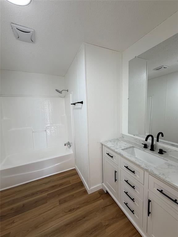 28834 Hubbard Street Leesburg, FL 34748 - Photo 21 of 22 a bathroom with a sink and a mirror