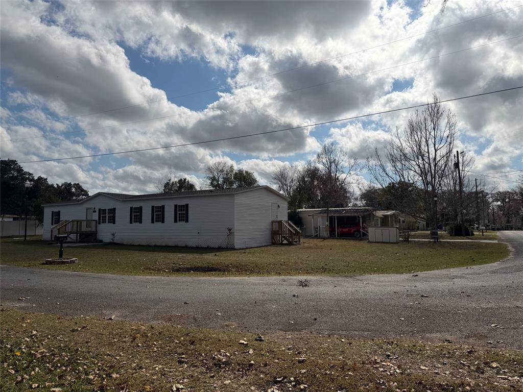 28834 Hubbard Street Leesburg, FL 34748 - Photo 3 of 22 a view of a big yard next to a yard
