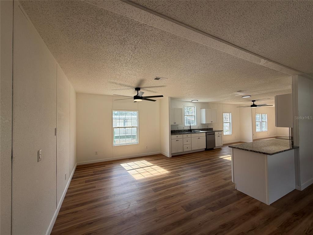 28834 Hubbard Street Leesburg, FL 34748 - Photo 8 of 22 a view of a kitchen cabinets and wooden floor