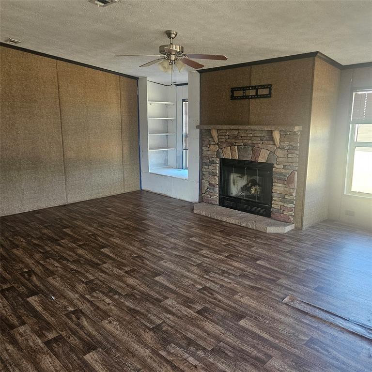 221 Farmhouse Road Springtown, TX 76082 - Photo 11 of 23 a view of empty room with wooden floor and fireplace