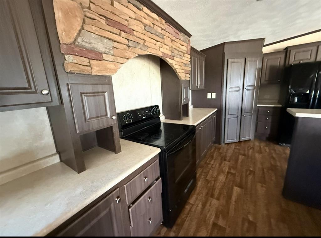 221 Farmhouse Road Springtown, TX 76082 - Photo 12 of 23 a kitchen with granite countertop a refrigerator a stove and a sink