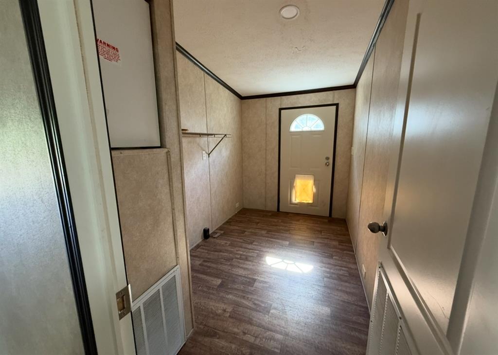 221 Farmhouse Road Springtown, TX 76082 - Photo 20 of 23 a view of a hallway with wooden floor