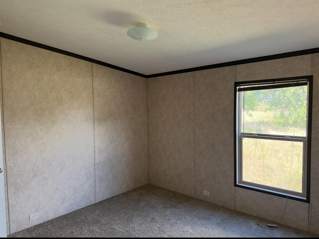 221 Farmhouse Road Springtown, TX 76082 - Photo 21 of 23 an empty room with a window