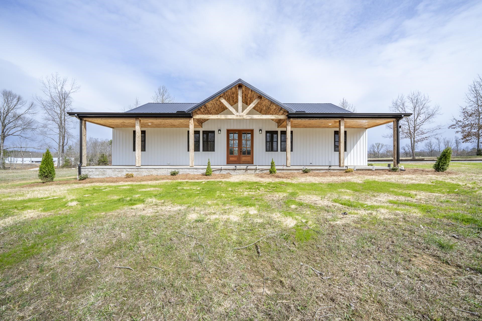1030 Robbins Road Collinwood, TN 38450 - Photo 1 of 40 View of front facade featuring covered porch, french doors, a metal roof, and a front yard