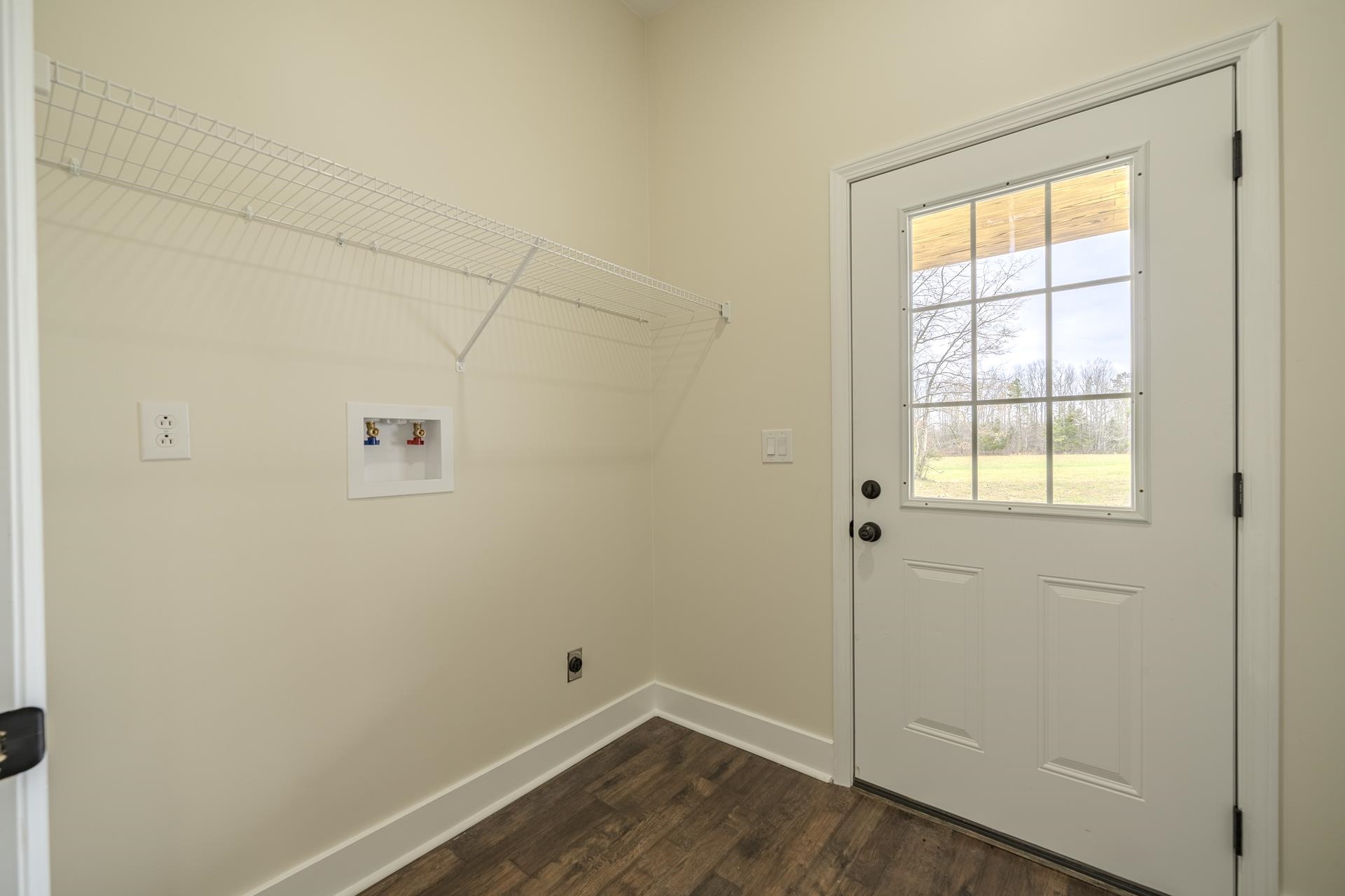 1030 Robbins Road Collinwood, TN 38450 - Photo 15 of 40 Laundry room with dark wood-style flooring, electric dryer hookup, and washer hookup