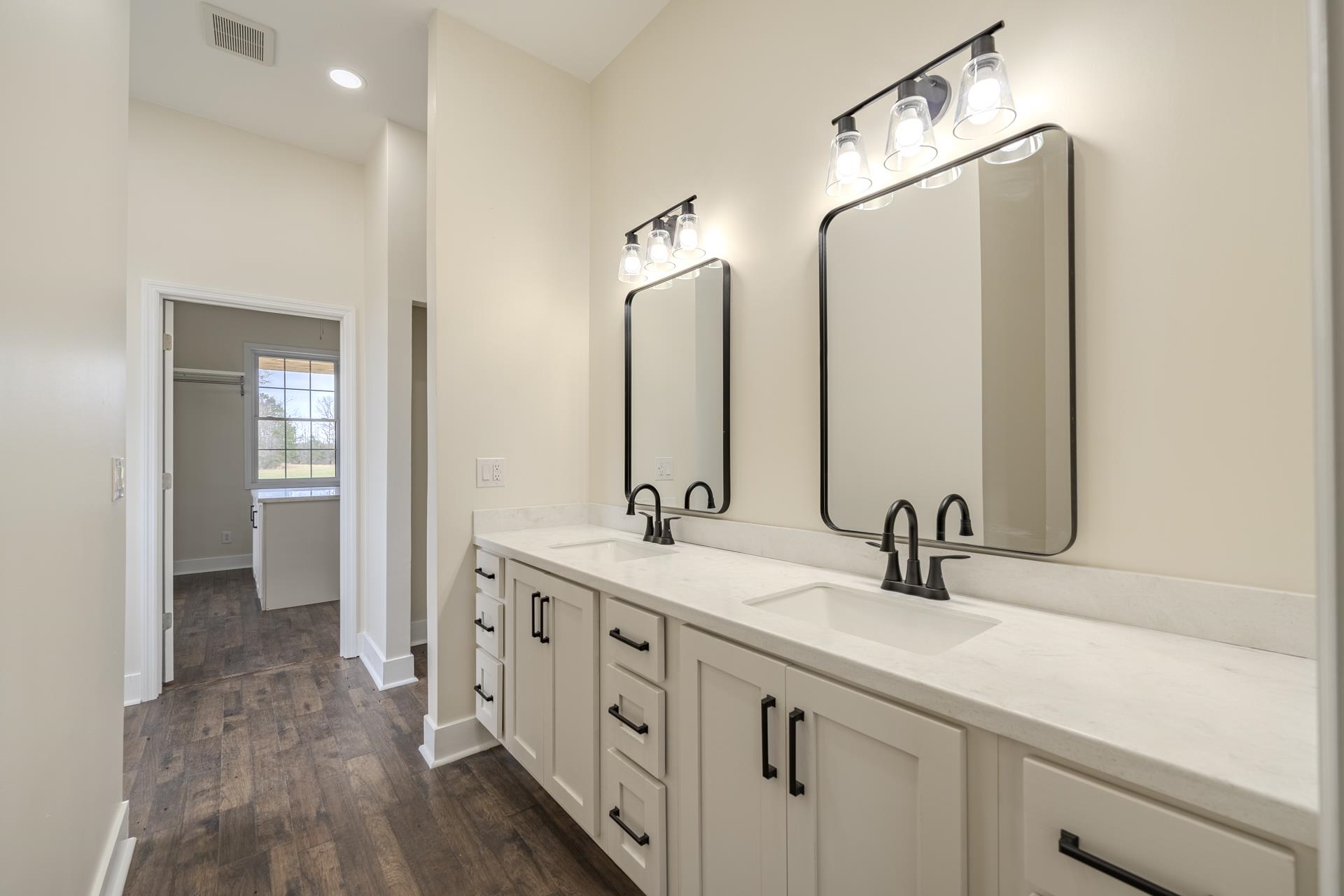 1030 Robbins Road Collinwood, TN 38450 - Photo 17 of 40 Bathroom featuring double vanity, dark wood-style flooring, and recessed lighting