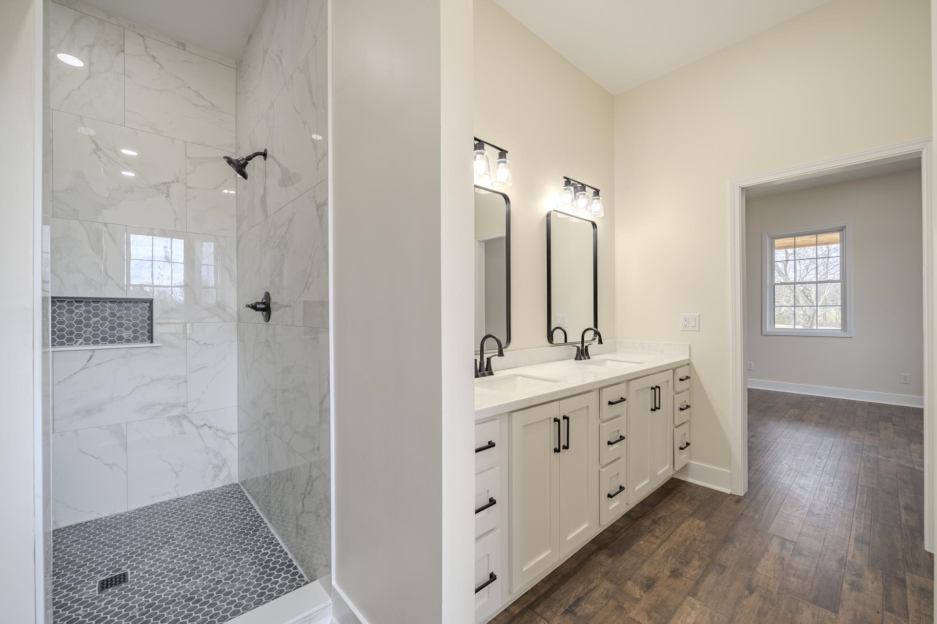 1030 Robbins Road Collinwood, TN 38450 - Photo 18 of 40 Full bath with double vanity, a marble finish shower, and dark wood finished floors
