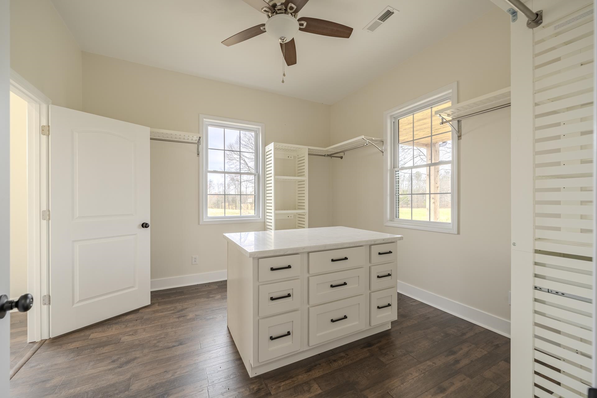 1030 Robbins Road Collinwood, TN 38450 - Photo 21 of 40 Walk in closet featuring dark wood-style floors and ceiling fan